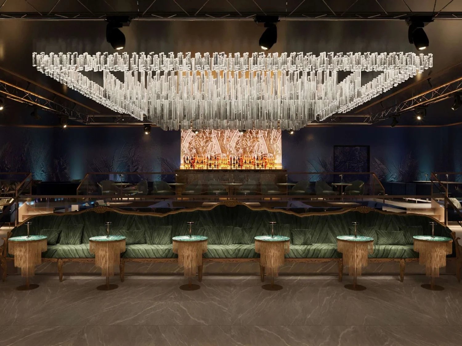 The bar under a glass chandelier, green velvet seating